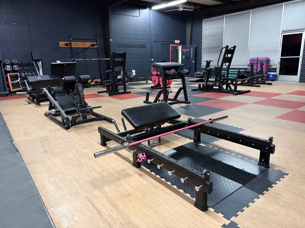 Glute and posterior-chain training area with plate-loaded machines at The Fitness Lab