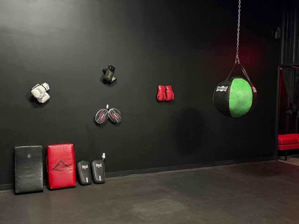 Boxing and conditioning studio with gloves and heavy bag at The Fitness Lab