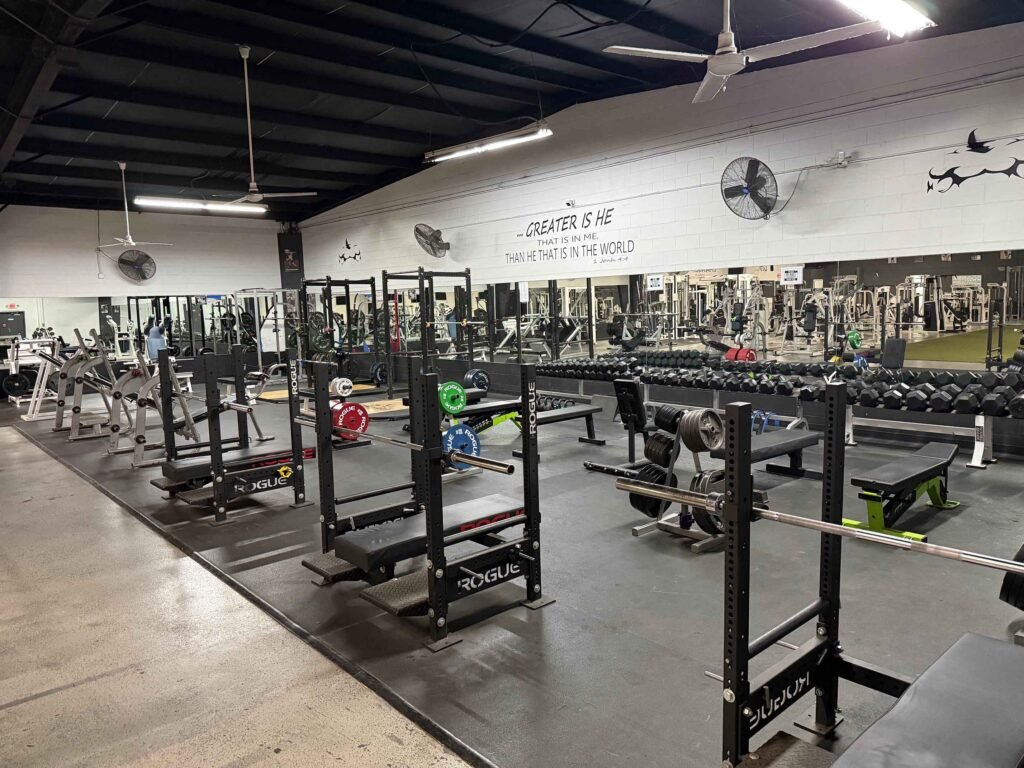 Main strength floor with Rogue power racks and dumbbell wall at The Fitness Lab